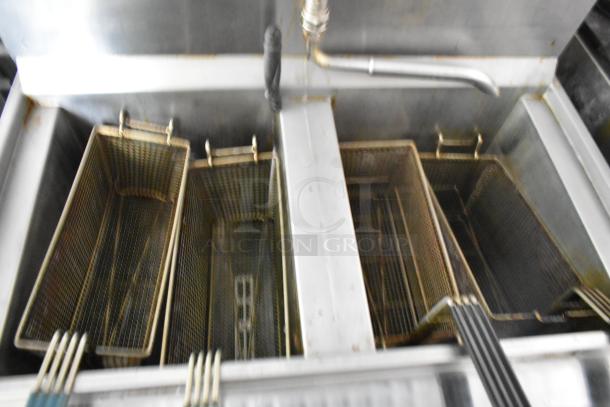 Henny Penny 2 Bay Fryer inside a fully equipped former Popeyes food trailer, showing metal fry baskets and a grease hood.
