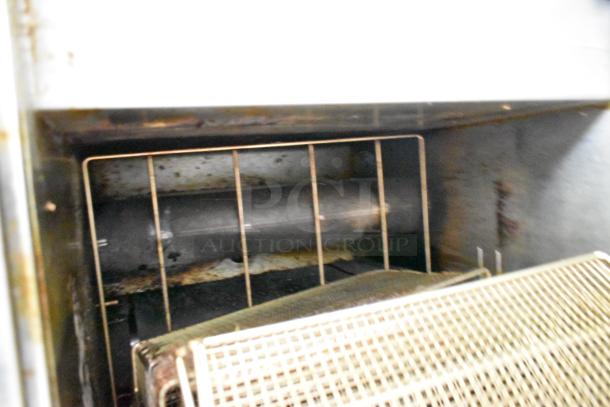 Interior view of a used Popeyes fried chicken food trailer showing kitchen hood and fryer area. Equipment shows signs of use.
