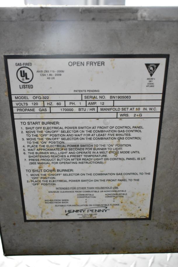 Henny Penny open fryer panel with model OFG-322, propane gas 170,000 BTU/hr, serial BN1905063, and operating instructions.