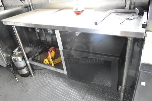 Fully outfitted Popeyes food trailer interior, featuring prep tables, a Henny Penny fryer, and storage. Ready for operation.