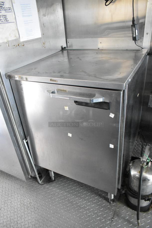 Mobile kitchen stainless cooler with sturdy top and handle, part of a former Popeyes food trailer setup.