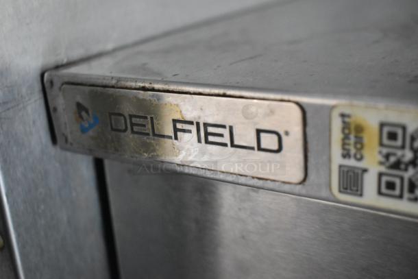 Delfield equipment label on the fully outfitted former Popeyes food trailer, indicating quality kitchen appliances.