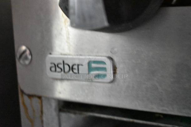Close-up of an Asber equipment tag on a former Popeyes mobile kitchen trailer. The surface shows wear.