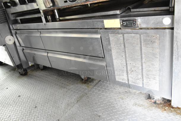 Fully outfitted Popeyes food trailer kitchen with fryers, prep tables, coolers, and range. Sold with clear title.
