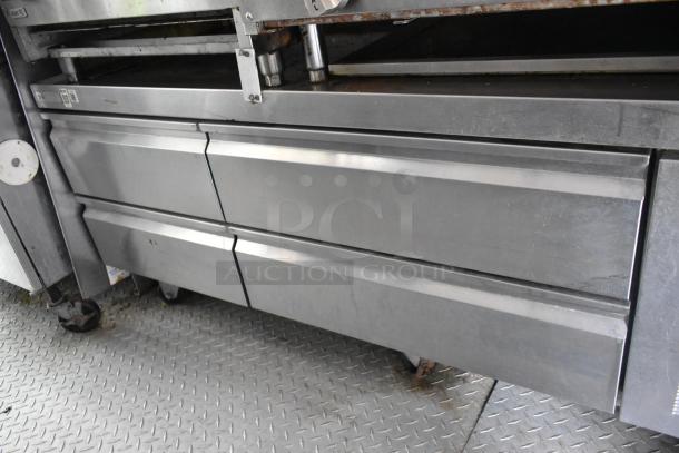 Stainless steel chef base with drawers in former Popeyes food trailer, suitable for mobile kitchen operations.