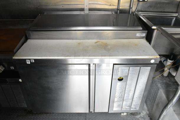 Fully outfitted Popeyes food trailer interior with stainless steel pizza prep table, showing slight use. Includes various appliances. Clear title.