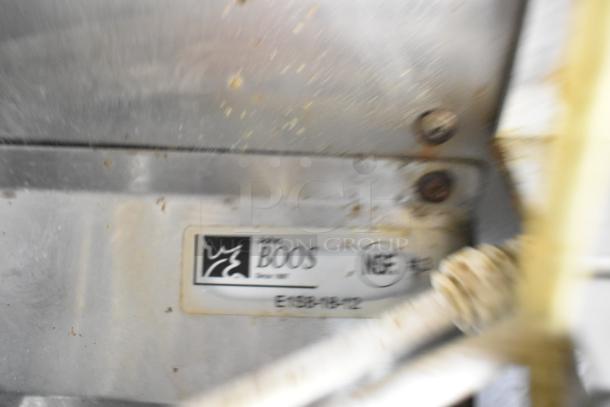 Food trailer interior showing a John Boos NSF-certified label on stainless steel. Visible bolts and electrical conduit.