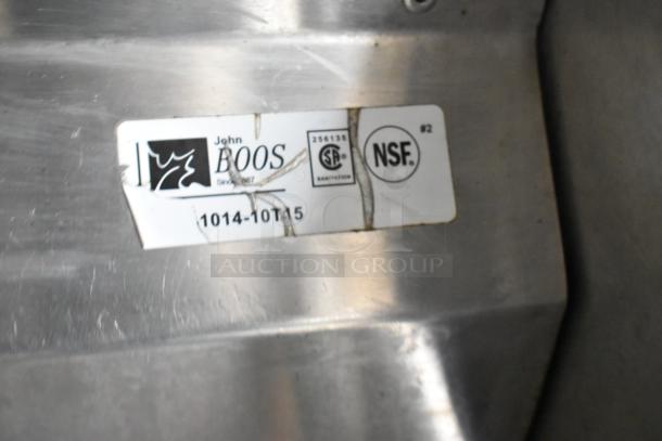 Label on stainless steel surface with text: "John Boos", "256135", "NSF", "1014-10T15". Sign of wear visible.