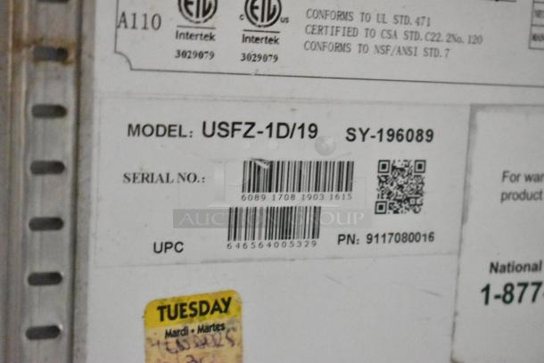 Food trailer appliance label showing model USFZ-1D/19, serial no., and certification info. Yellow "Tuesday" label visible.