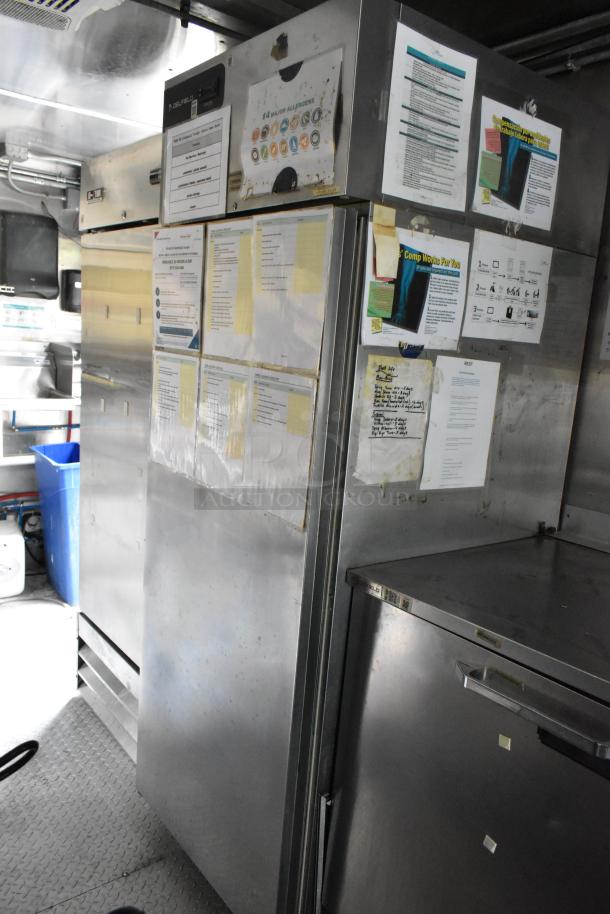 Former Popeyes food trailer interior showing stainless steel surfaces, refrigeration units, and posted menus.