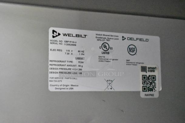 Welbilt label on the commercial refrigerator, model GBF1P-S-IJ, detailing electrical requirements and refrigerant type.