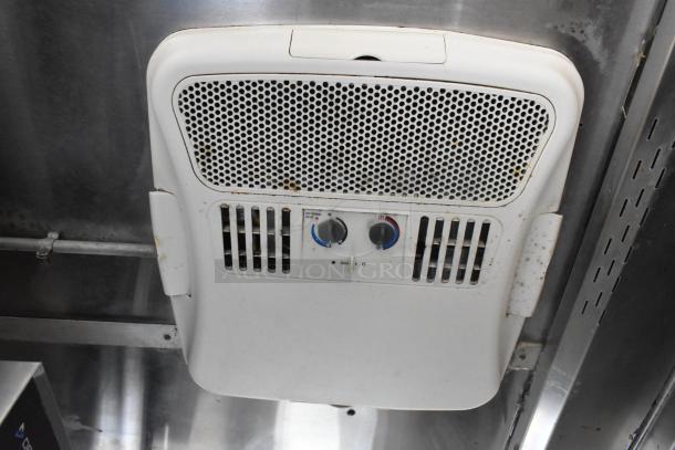 Interior view of Popeyes food trailer showing ceiling-mounted vent with temperature controls, part of fully outfitted mobile kitchen.