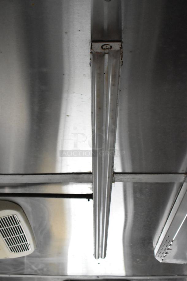 Interior of Popeyes food trailer showing stainless steel ceiling with light fixture; part of mobile kitchen equipment.