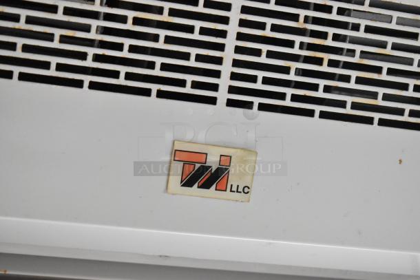 Food trailer ventilation system with TI LLC label. Slight wear visible. Equipped for a mobile kitchen setup.