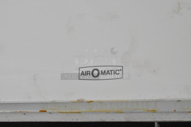 Air-o-Matic logo on a white background, showing signs of wear and grime buildup.