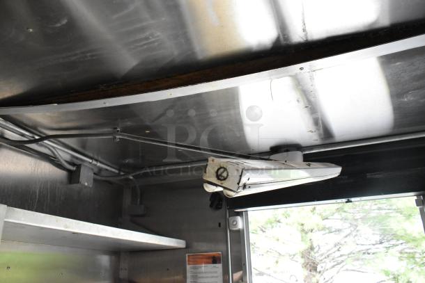 Interior ceiling view of a fully outfitted former Popeyes food trailer, showing ventilation and wiring. Suitable for a mobile kitchen.