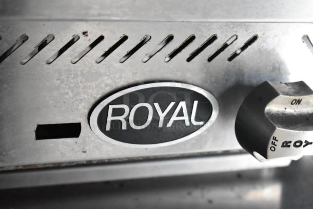 Metal appliance in a food trailer with a "ROYAL" brand label and control knob on a stainless steel surface.