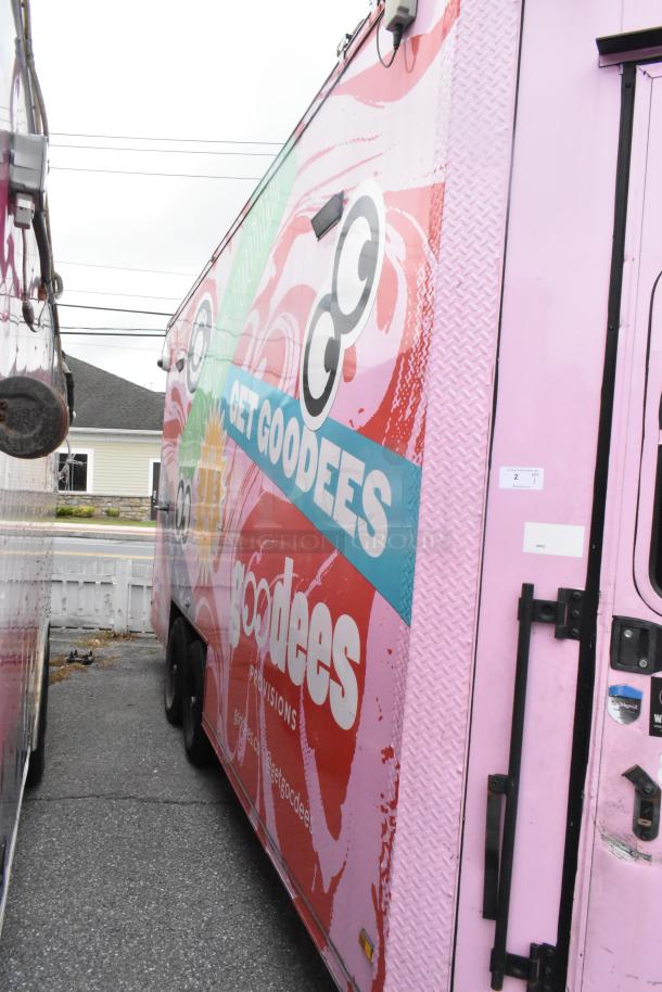 Fully outfitted 2020 Goodees food trailer in pink with graphic designs. Includes cooler, freezer, shelving, and sinks.
