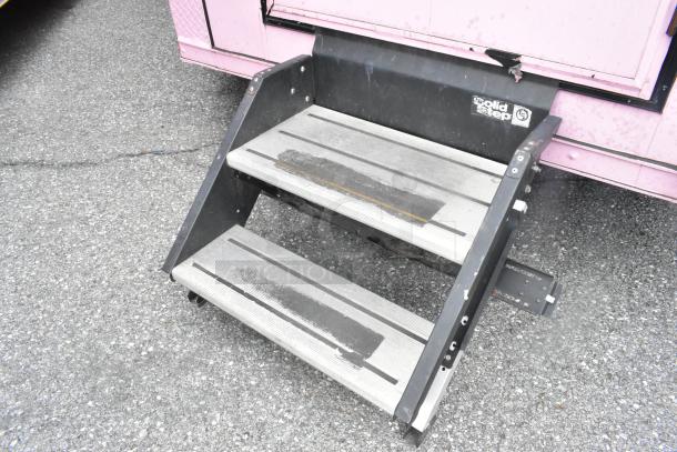 SolidStep entrance steps attached to a pink Goodees food trailer, showing wear.