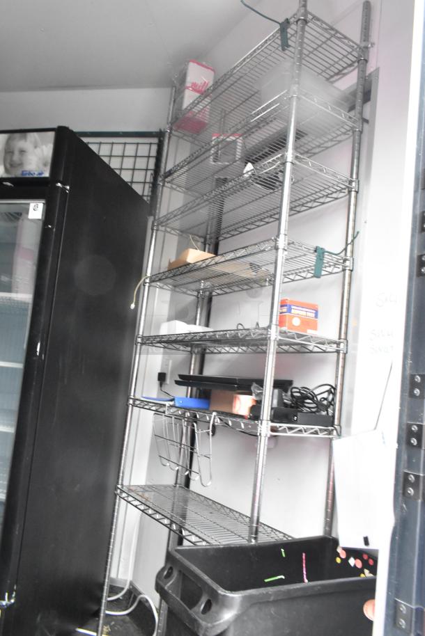 2020 Goodees Food Trailer interior with shelving units and a 2-door merchandiser. Equipped for mobile kitchen.