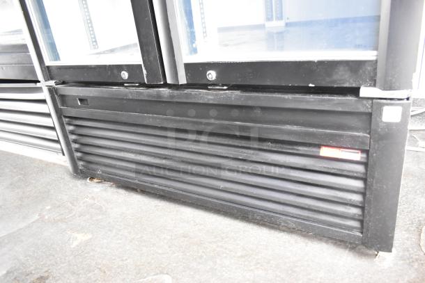 Black two-door cooler and freezer merchandiser from a 2020 Goodees food trailer, featuring clear glass doors.