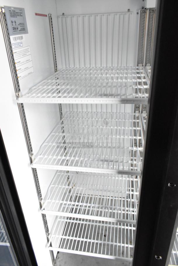 Empty cooler with white wire shelves inside a 2020 Goodees food trailer, showcasing ample storage space.