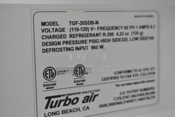 Close-up of Turbo Air cooler label. Model TGF-35SDB-N, charged refrigerant R-290, voltage 110-120V, made in Korea.