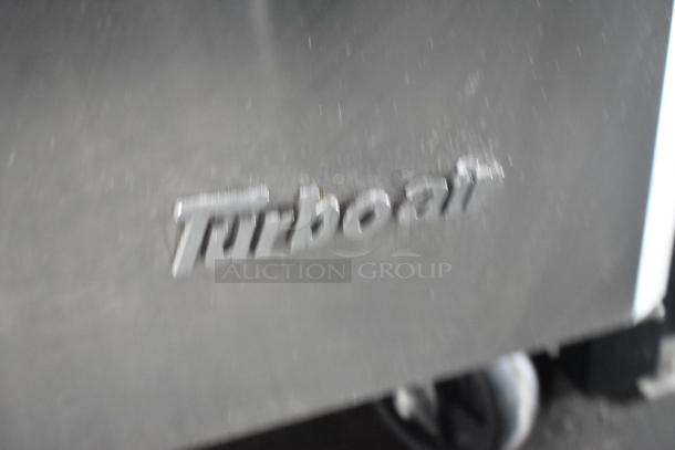 Blurry close-up of "Turboair" logo on metal surface of the 2020 Goodees Food Trailer.