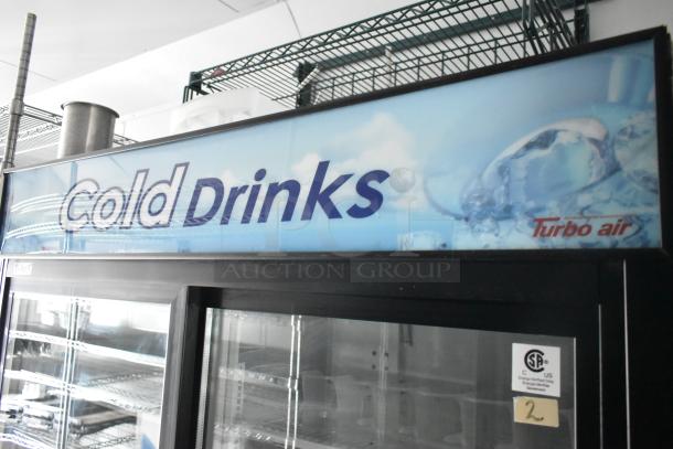 Turbo Air two-door cooler, glass front. "Cold Drinks" label. Includes shelving. CSA certified. Part of Goodees food trailer.
