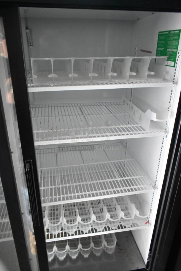 Interior of a 2-door cooler with empty shelves and compartmental dividers, ready for use in a Goodees food trailer.