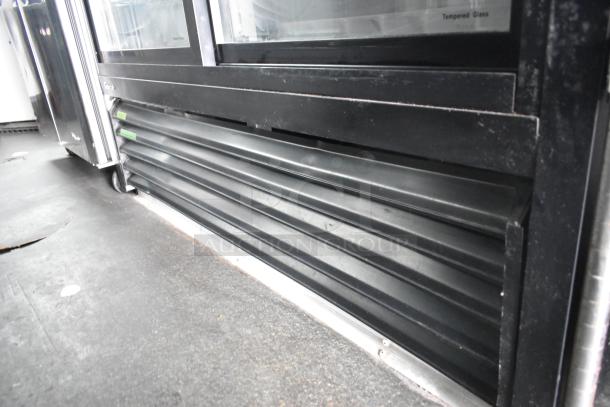 2020 Goodees food trailer interior showing two-door cooler and freezer merchandisers. Features black trim and tempered glass.