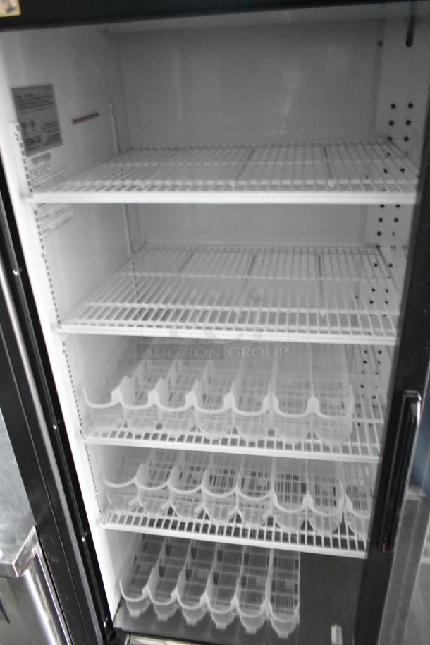 Two-door cooler merchandiser interior with wire shelving and clear beverage organizers. Clean and in ready-to-use condition.