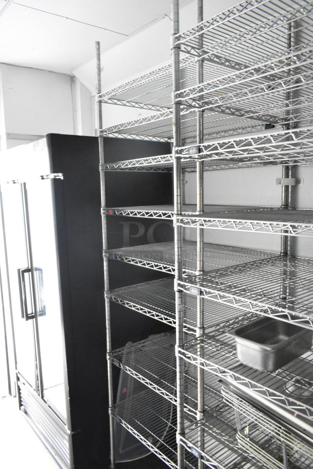 2020 Goodees food trailer interior with metal shelving and a two-door cooler. Includes sinks and a clear title. VIN visible.