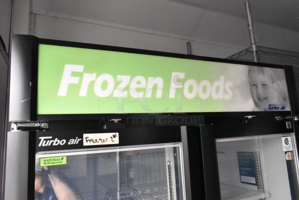 Turbo Air freezer merchandiser in food trailer, featuring "Frozen Foods" signage. Includes clear title and VIN details.