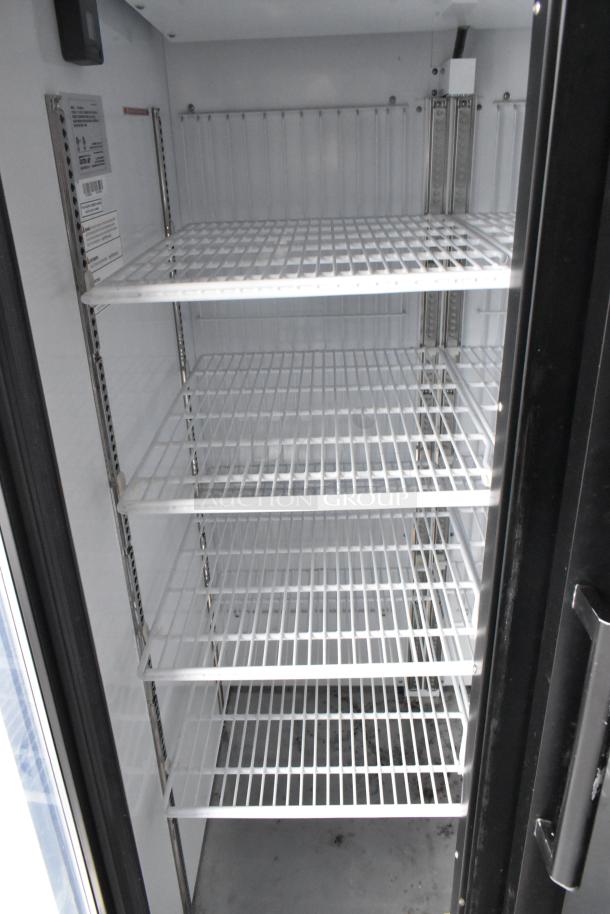 Interior view of a 2-door cooler in a 2020 Goodees food trailer, featuring metal shelves and temperature settings.