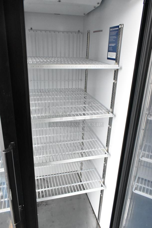 Empty two-door cooler interior with white wire shelves, part of a 2020 Goodees food trailer package.