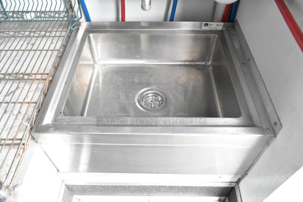 Stainless steel sink in a 2020 Goodees food trailer. Appears in good condition, with shelving on the left.
