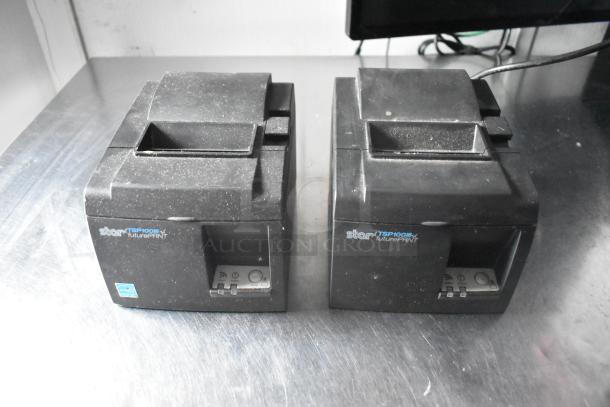 Star TSP100 futurePRNT printers on metal surface, wireless capability indicated, slight wear visible.