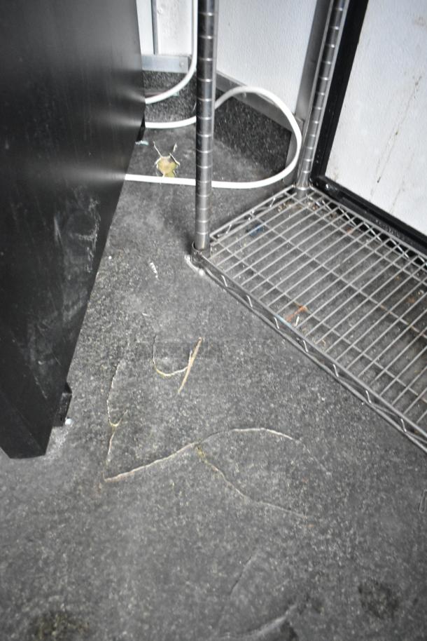 Interior of 2020 Goodees food trailer showing metal shelving units and wiring. Durable flooring visible.