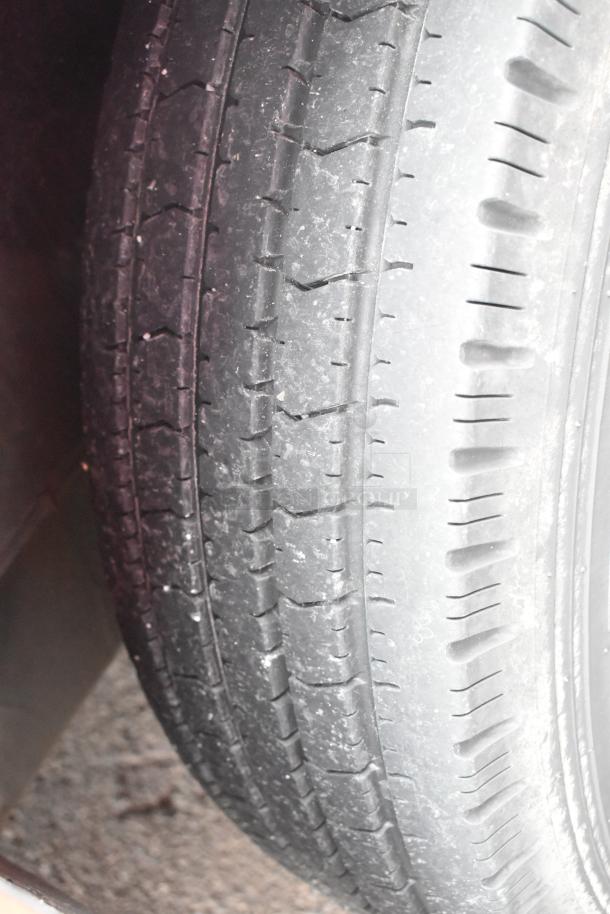Close-up view of a tire from the 2020 Goodees Food Trailer, showing tread condition and detail.