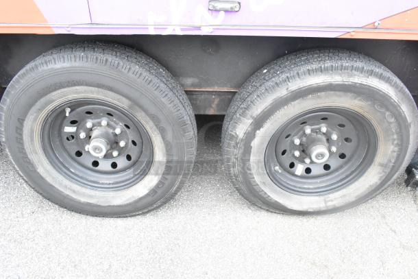 Dual wheels of a 2020 Goodees food trailer with Goodyear tires, showcasing sturdy black steel rims.