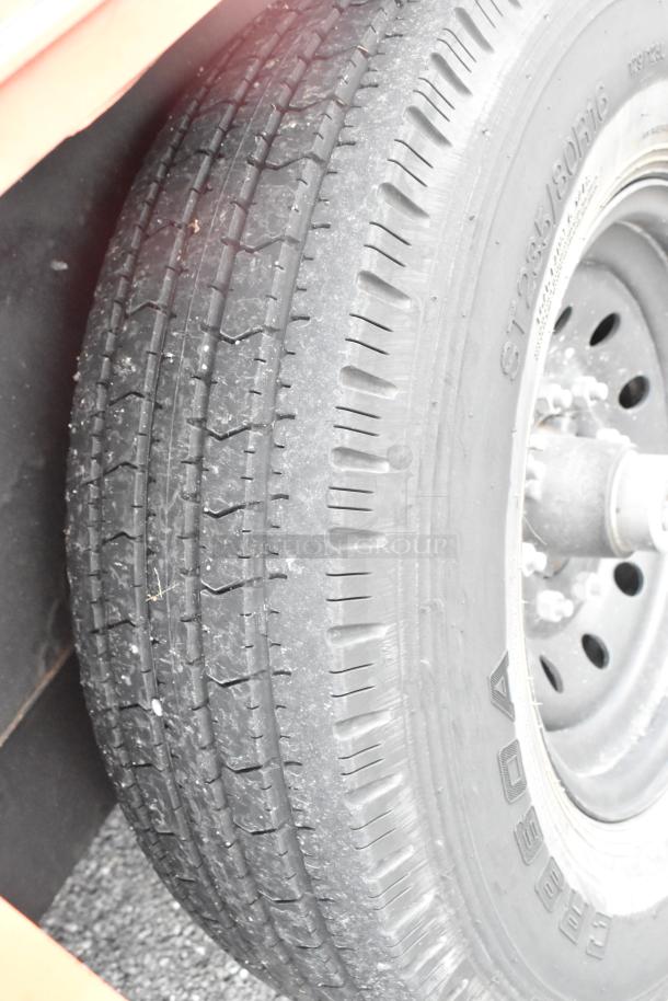 Close-up of a tire on the 2020 Goodees food trailer. Tire markings include size and brand details. Clean condition.