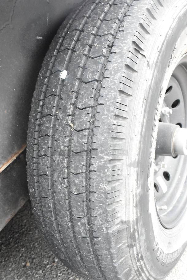Close-up of a tire on a 2020 Goodees food trailer, showcasing tread condition. Trailer sold with a clear title.