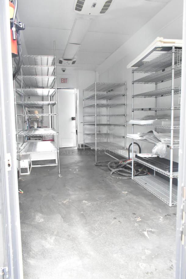 Interior of 2020 Southern Dimensions Group trailer with metal shelving units. Clean and spacious. GVWR 14,000 LB.