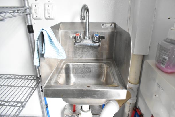 Stainless steel sink with dual faucet handles in a 2020 Southern Dimensions Group Trailer, featuring a clear, functional setup.