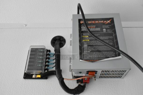 PowerMax charger from 2020 Southern Dimensions Group Trailer. Features electrical connections and label with specs.