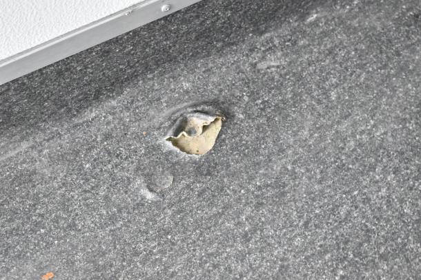 Damaged section of 2020 Southern Dimensions Group trailer floor, featuring a tear and exposed material underneath.