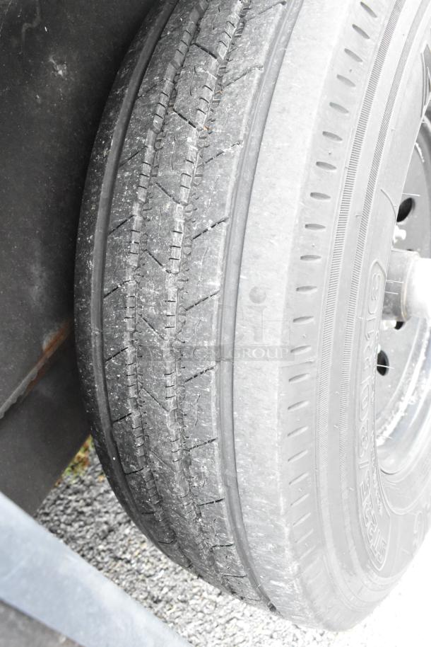 Close-up view of a tire on the 2020 Southern Dimensions Group Trailer, showing tread wear and wheel detail.