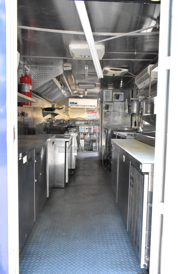 Brand new food trailer with full kitchen: grease hood, Henny Penny fryer, coolers, freezers, prep tables, clear title.