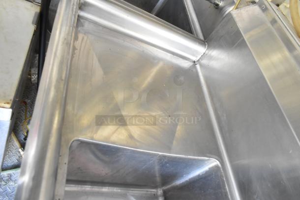 Interior of a food trailer kitchen, showing a stainless steel sink and prep area in excellent condition.